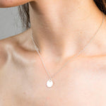 Sterling Silver Necklace with a solid circle pendent, worn on a model.