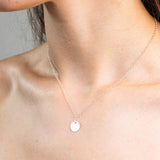 Sterling Silver Necklace with a solid circle pendent, worn on a model.