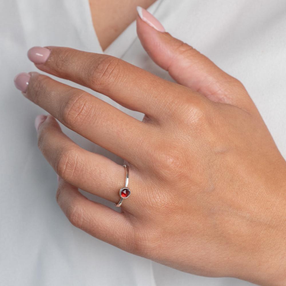 Model wears Garnet Hammered Sterling Silver Ring , with a white blouse and frenchtip manicured nails.