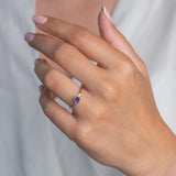 Model wears Iolite Hammered Sterling Silver Ring , with a white blouse and frenchtip manicured nails.