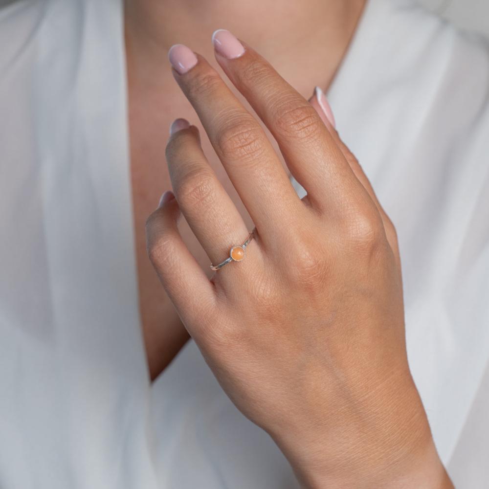 Model wears Peach Moonstone Hammered Sterling Silver Stacking Ring , with a white blouse and frenchtip manicured nails.