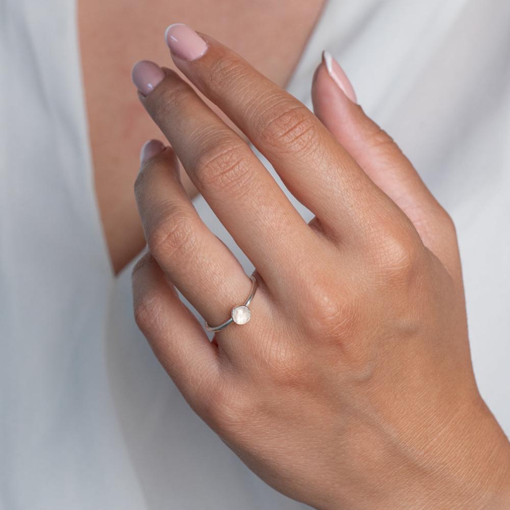 Model wears Rainbow Moonstone Hammered Sterling Silver Stacking Ring , with a white blouse and frenchtip manicured nails.