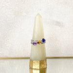 A Sterling Silver Stacking Rings Set made up with Lapis, Citrine and Amethyst gemstones, displayed on a ring holder.