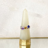 A Sterling Silver Stacking Rings Set made up with Lapis, Citrine and Amethyst gemstones, displayed on a ring holder.