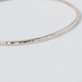 Handmade Hammered Sterling Silver Bangle close up on white background 