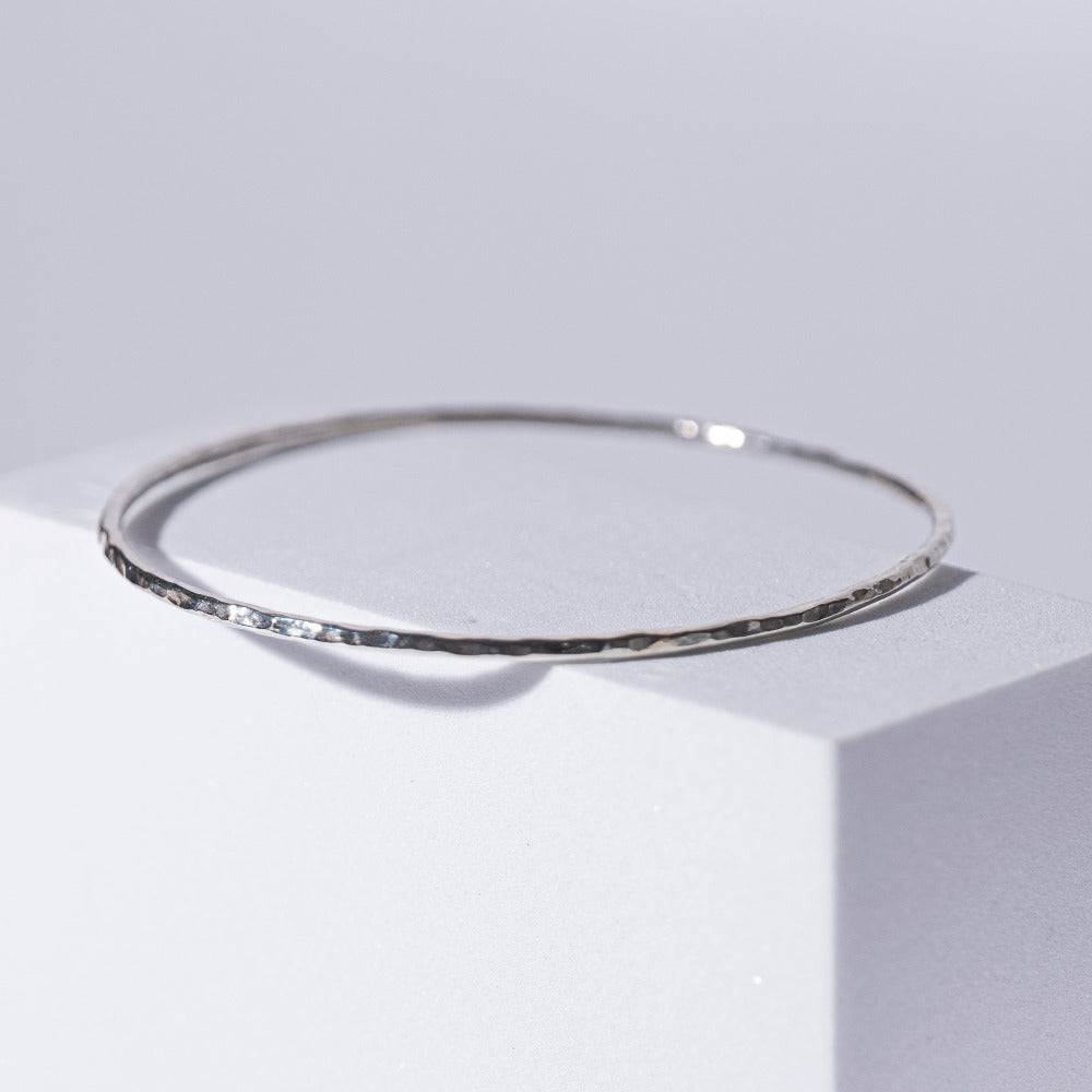 Handmade Hammered Sterling Silver Bracelet (Bangle) displayed on white box