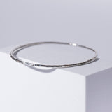 Handmade Hammered Sterling Silver Bracelet (Bangle) displayed on white box