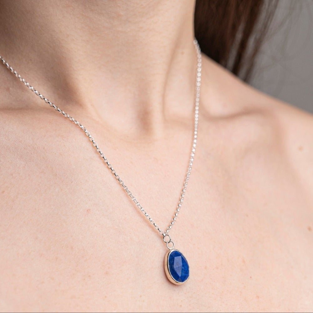 Handmade Lapis lazuli Gemstone Sterling Silver Pendent worn on a model, sideview.