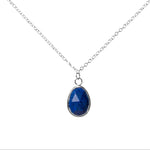 Handmade Lapis lazuli Gemstone Sterling Silver Pendent displayed on a whitebackground.