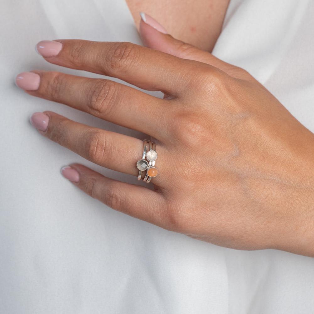 Model wears Moonstone Trio Hammered Sterling Silver Stacking Ring , with a white blouse and frenchtip manicured nails.