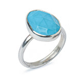 Turquoise Sterling Silver Statement Ring on a White Background, side view.