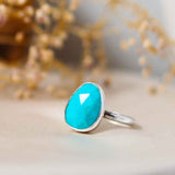 Turquoise Sterling Silver Statement Ring on a silk and dried flower background