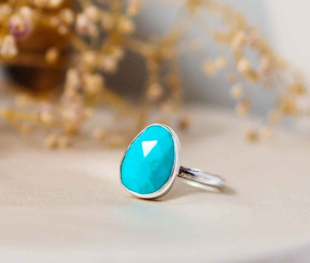 Turquoise Sterling Silver Statement Ring on a silk and dried flower background