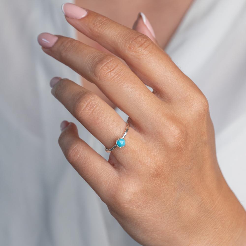 Turquoise gemstone Sterling Silver Stacking Ring with Hammered Textured band.  Worn on models hand.